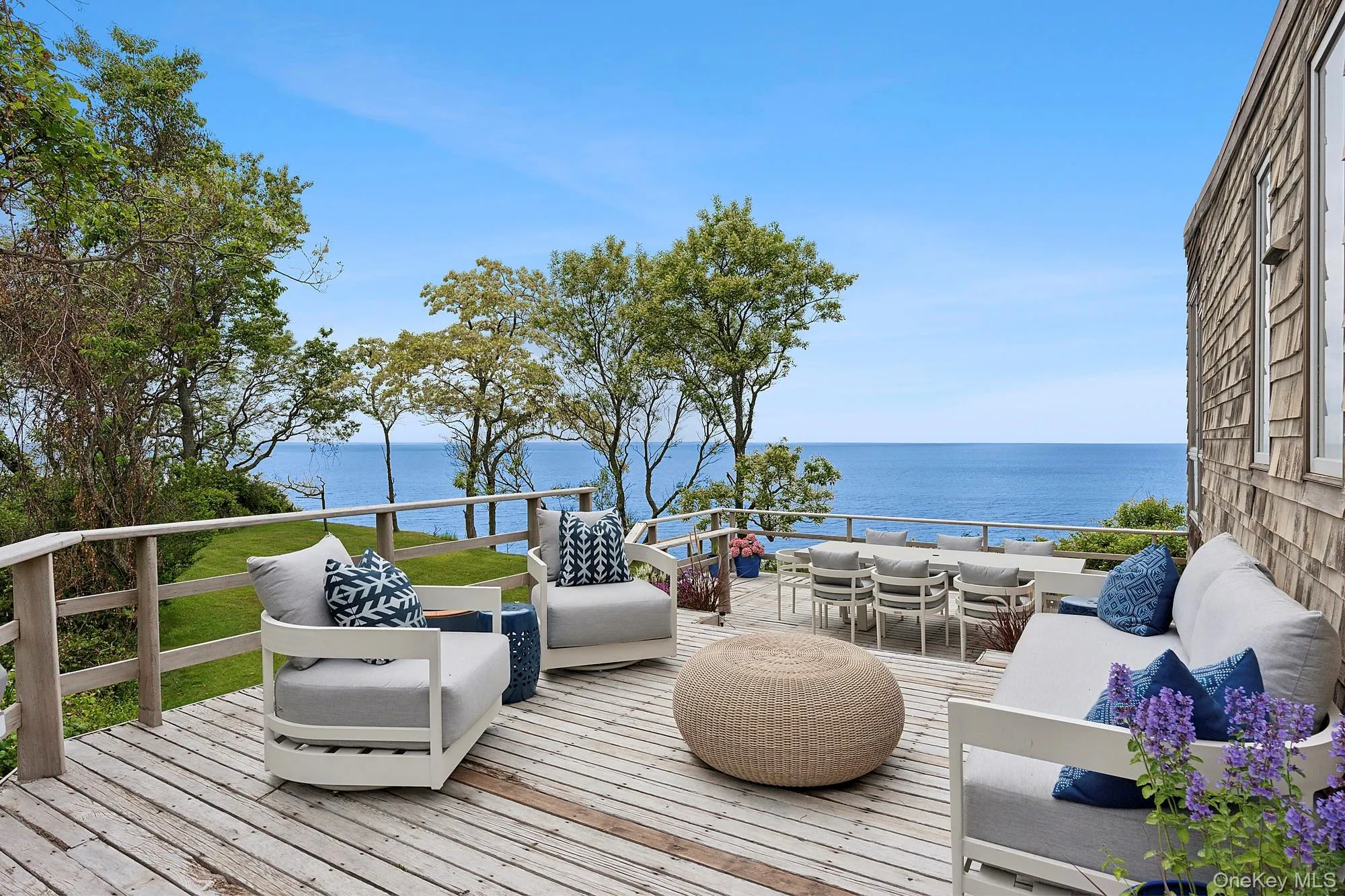 Wooden deck featuring an outdoor living space, a water view, and outdoor dining area Wooden deck featuring an outdoor living space, a water view, and outdoor dining area