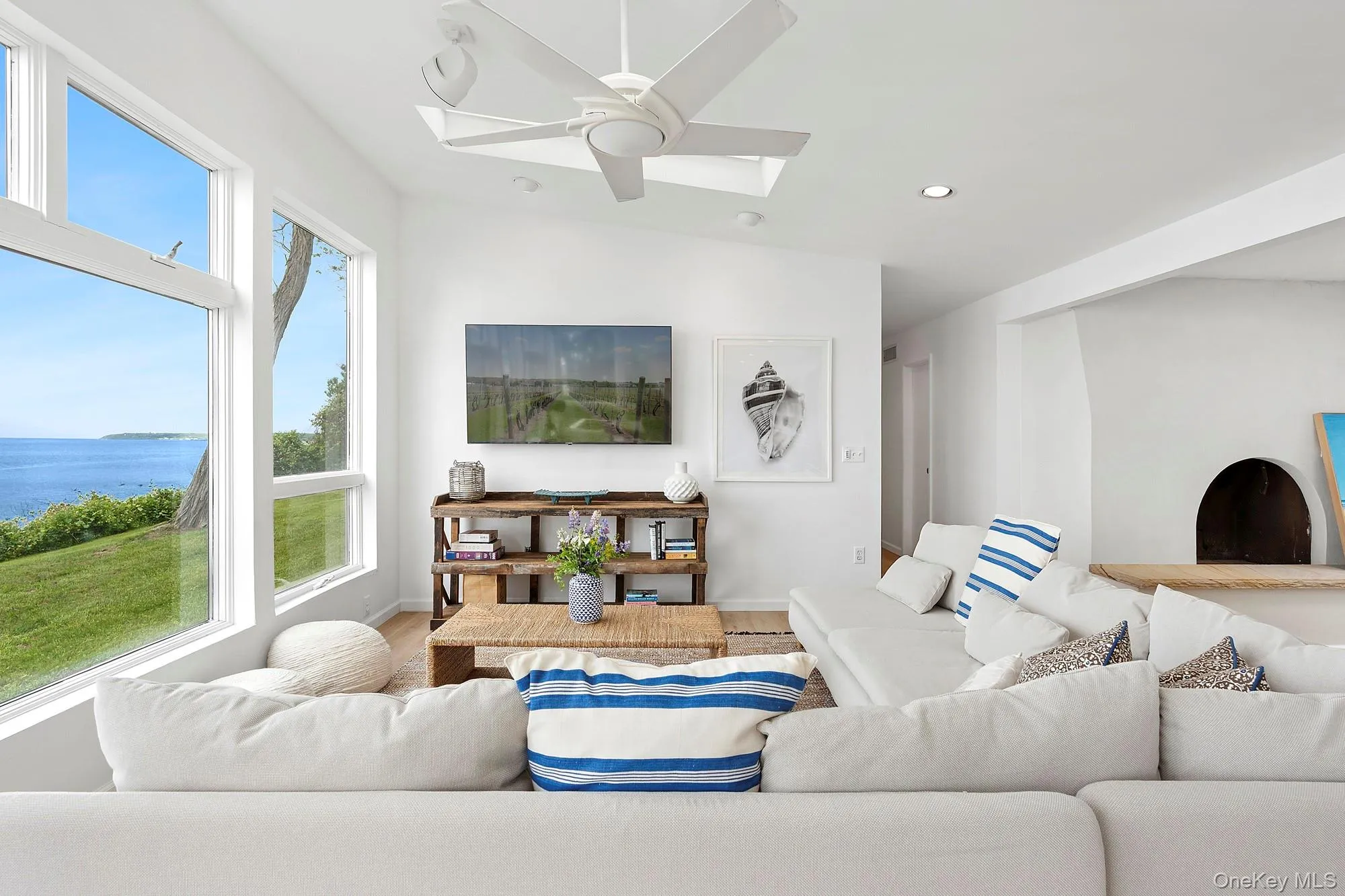 Living room featuring wood finished floors, ceiling fan, and recessed lighting Living room featuring wood finished floors, ceiling fan, and recessed lighting