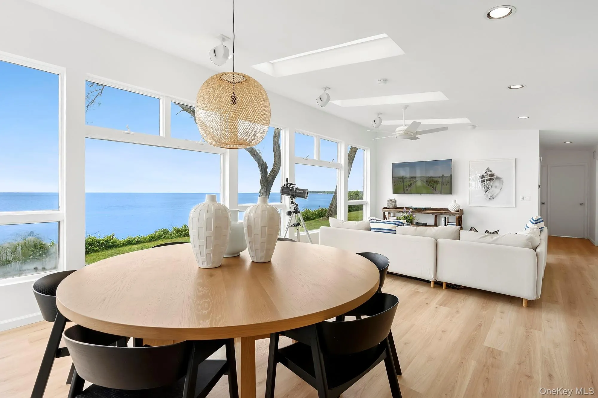 Dining space featuring a skylight, light wood-style floors, recessed lighting, and ceiling fan Dining space featuring a skylight, light wood-style floors, recessed lighting, and ceiling fan