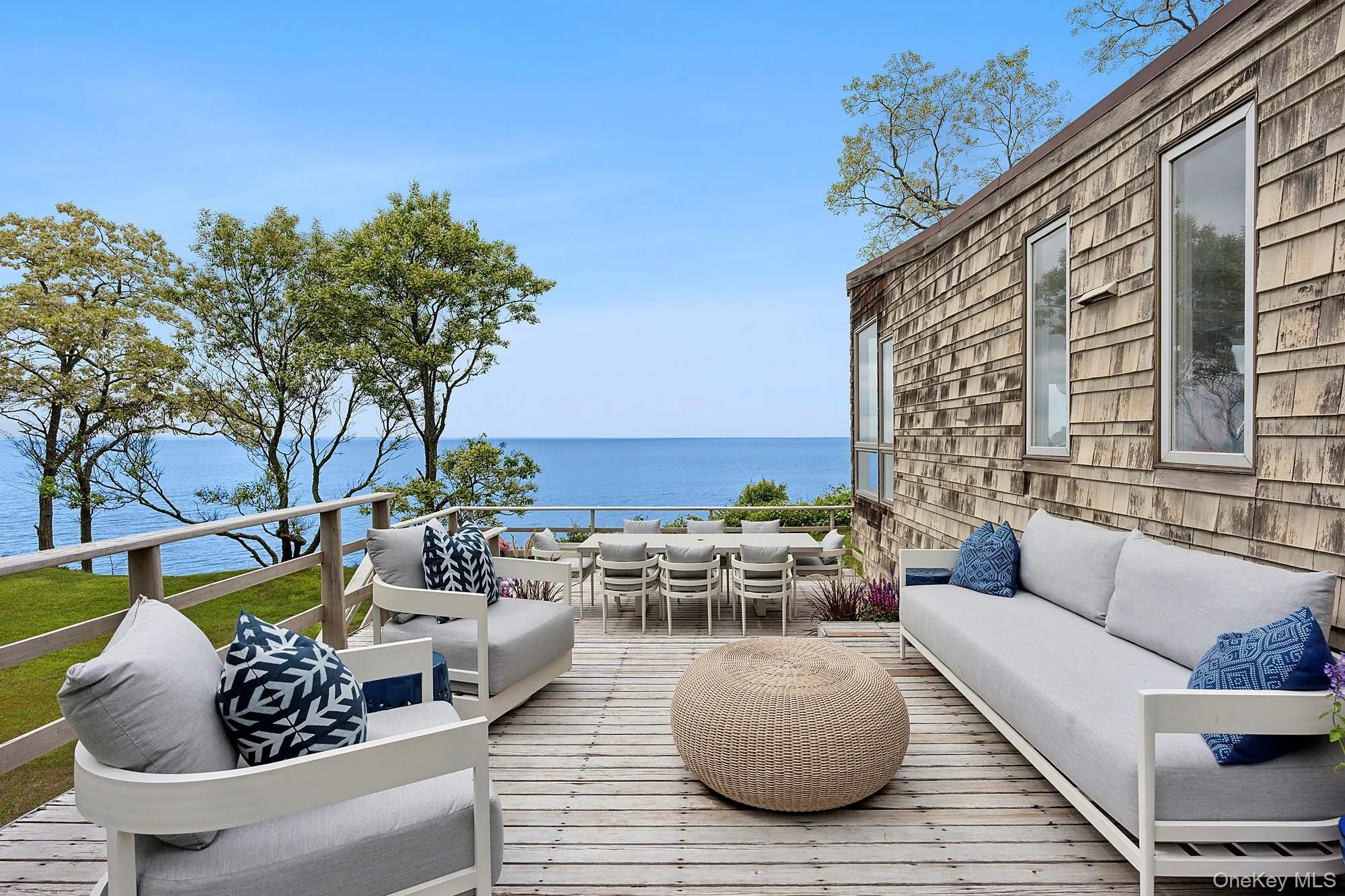 Wooden deck featuring an outdoor living space, a water view, and outdoor dining space Wooden deck featuring an outdoor living space, a water view, and outdoor dining space