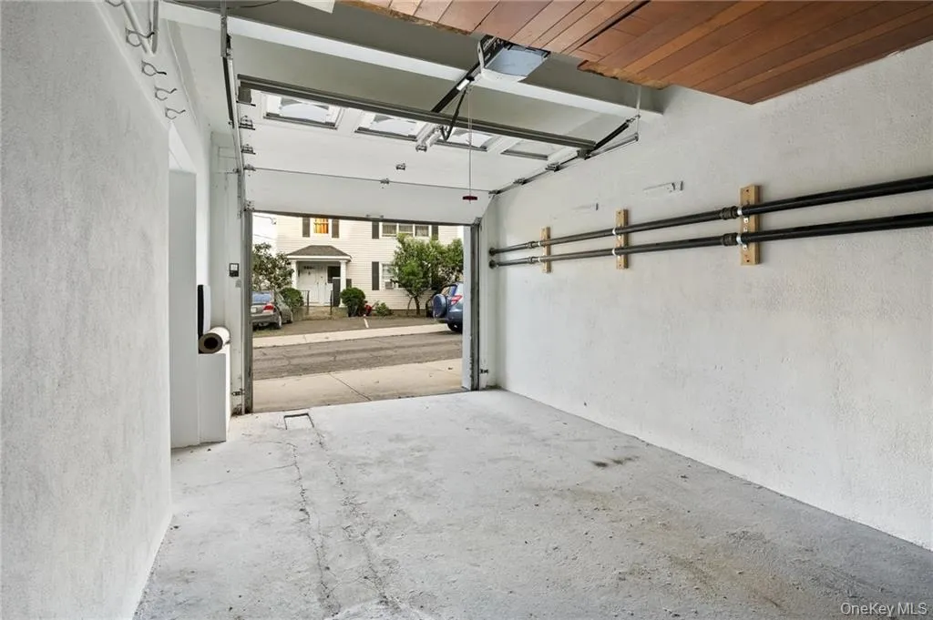Garage featuring a textured wall and wooden ceiling Garage featuring a textured wall and wooden ceiling