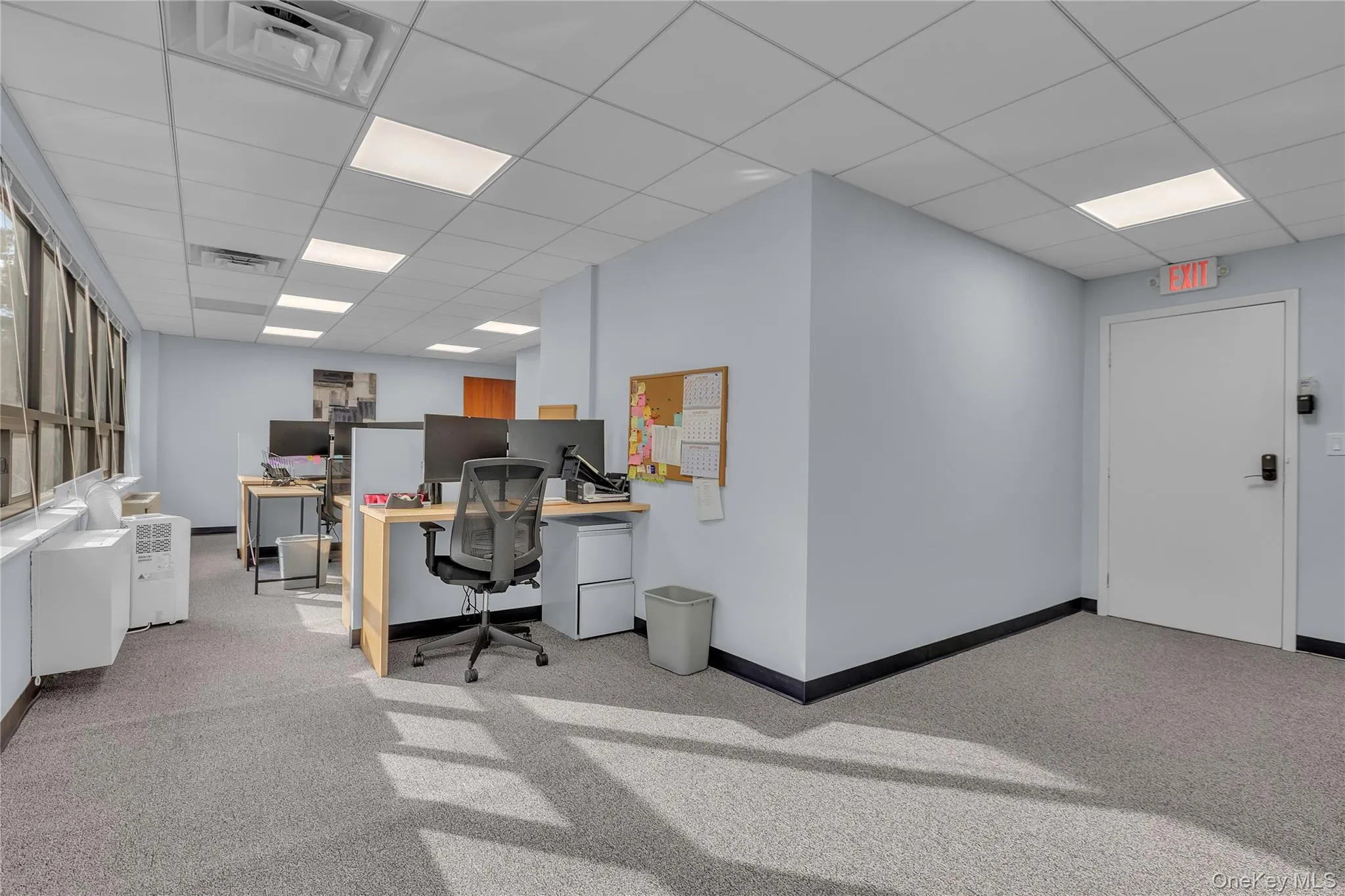 Office space with a paneled ceiling Office space with a paneled ceiling