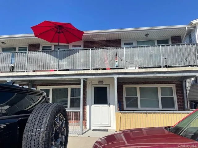 View of front of home featuring brick siding and a balcony View of front of home featuring brick siding and a balcony