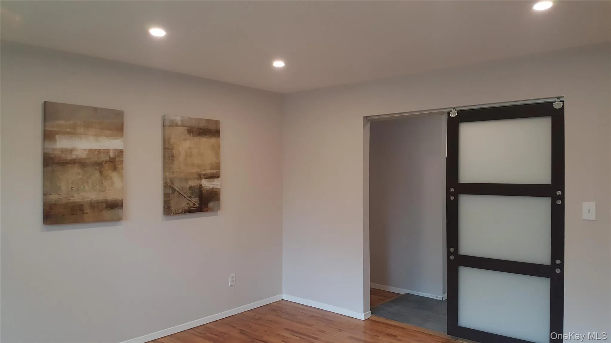Unfurnished bedroom with light wood-style flooring and recessed lighting Unfurnished bedroom with light wood-style flooring and recessed lighting