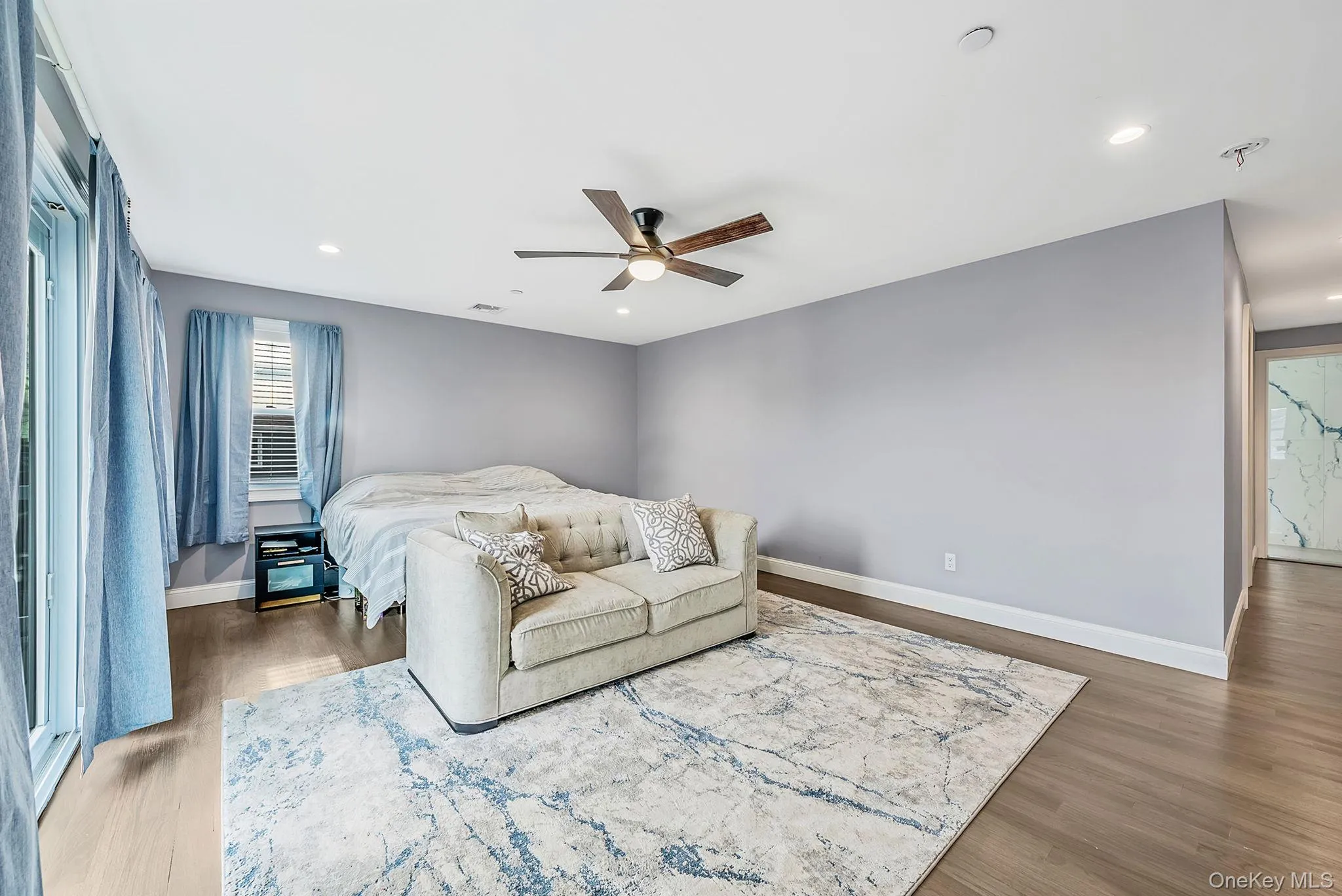 Bedroom featuring ceiling fan, light wood-style floors, and recessed lighting Bedroom featuring ceiling fan, light wood-style floors, and recessed lighting