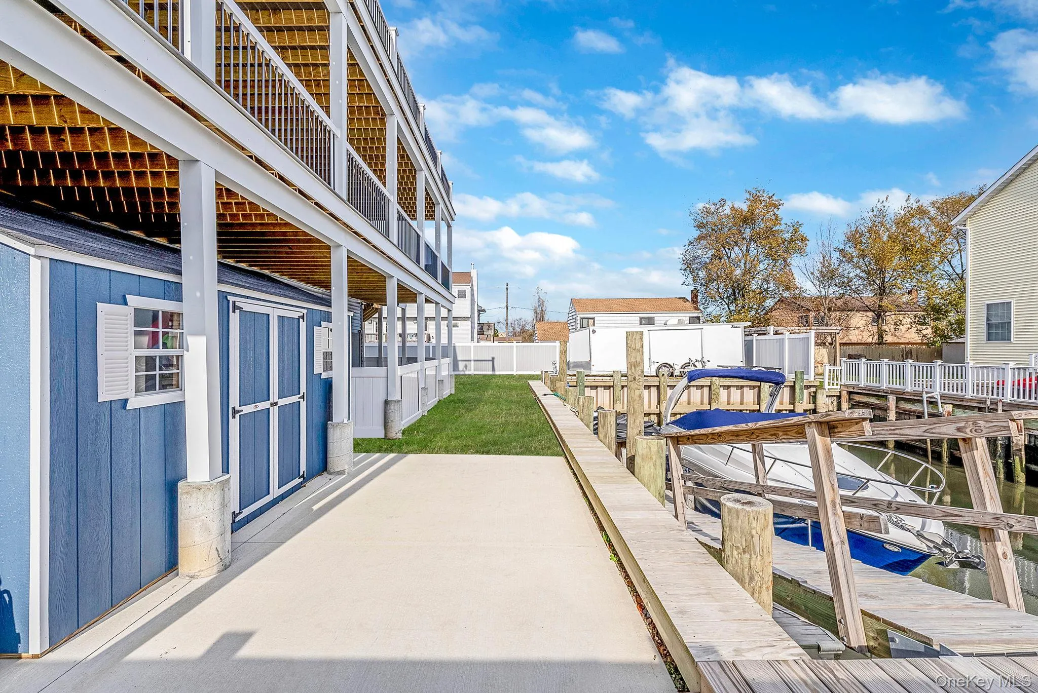 Dock featuring a patio and boat lift Dock featuring a patio and boat lift