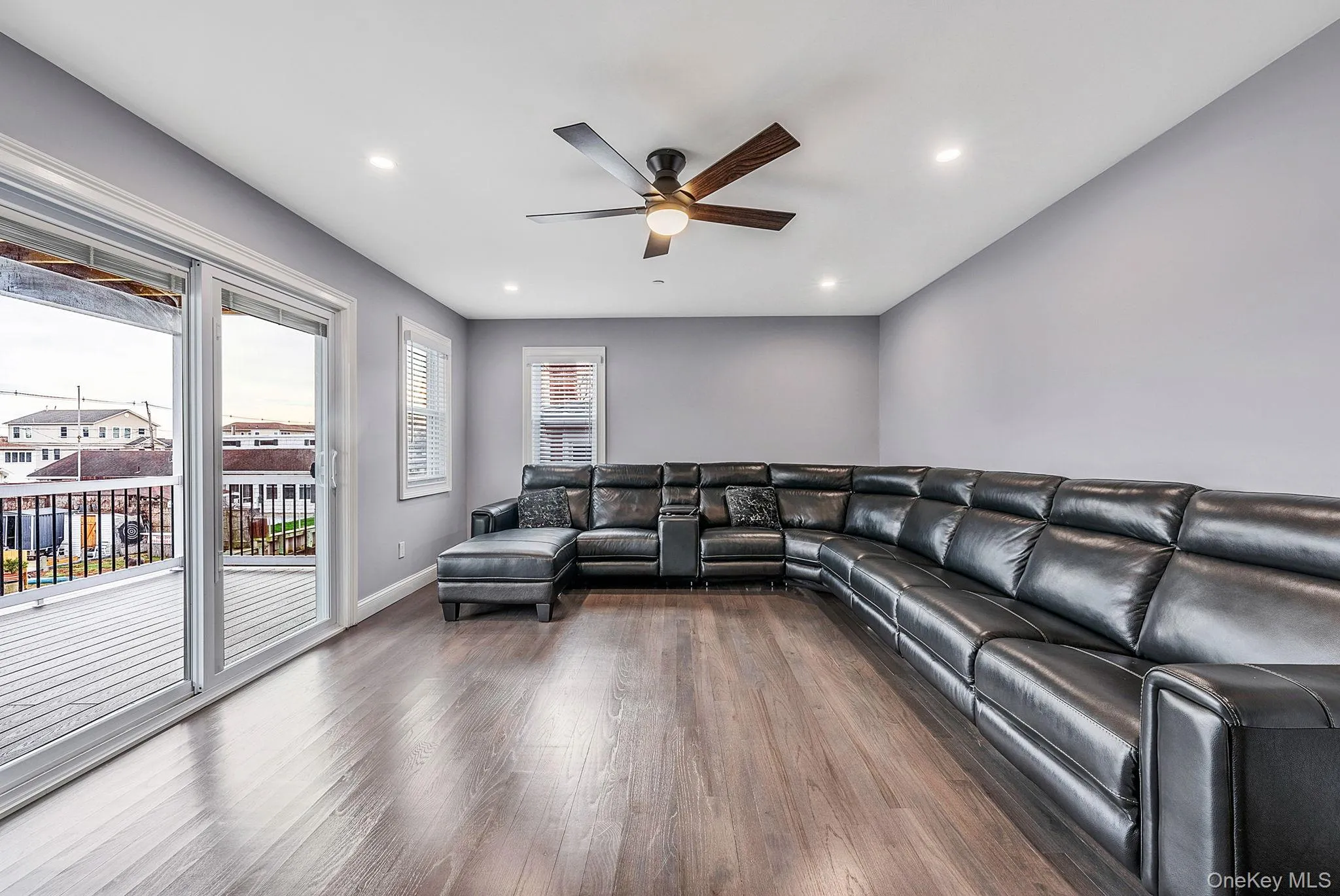 Living room featuring wood finished floors, ceiling fan, and recessed lighting Living room featuring wood finished floors, ceiling fan, and recessed lighting