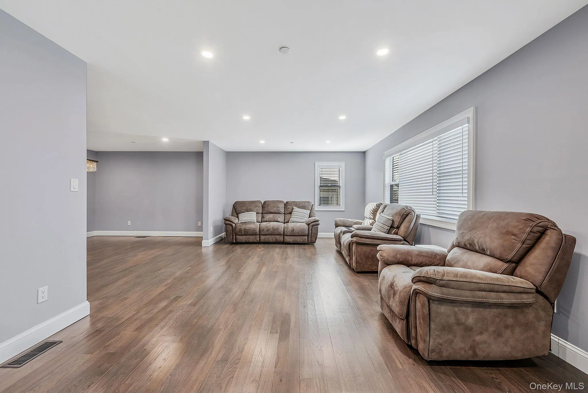 Living area with recessed lighting and dark wood finished floors Living area with recessed lighting and dark wood finished floors