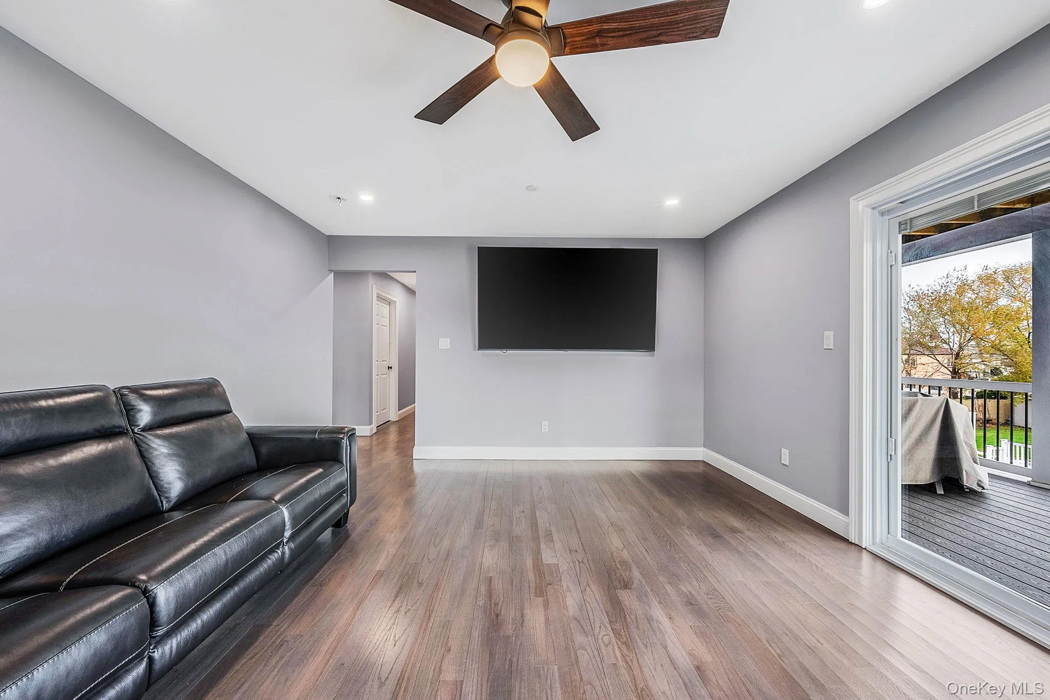 Living area featuring ceiling fan, wood finished floors, and recessed lighting Living area featuring ceiling fan, wood finished floors, and recessed lighting