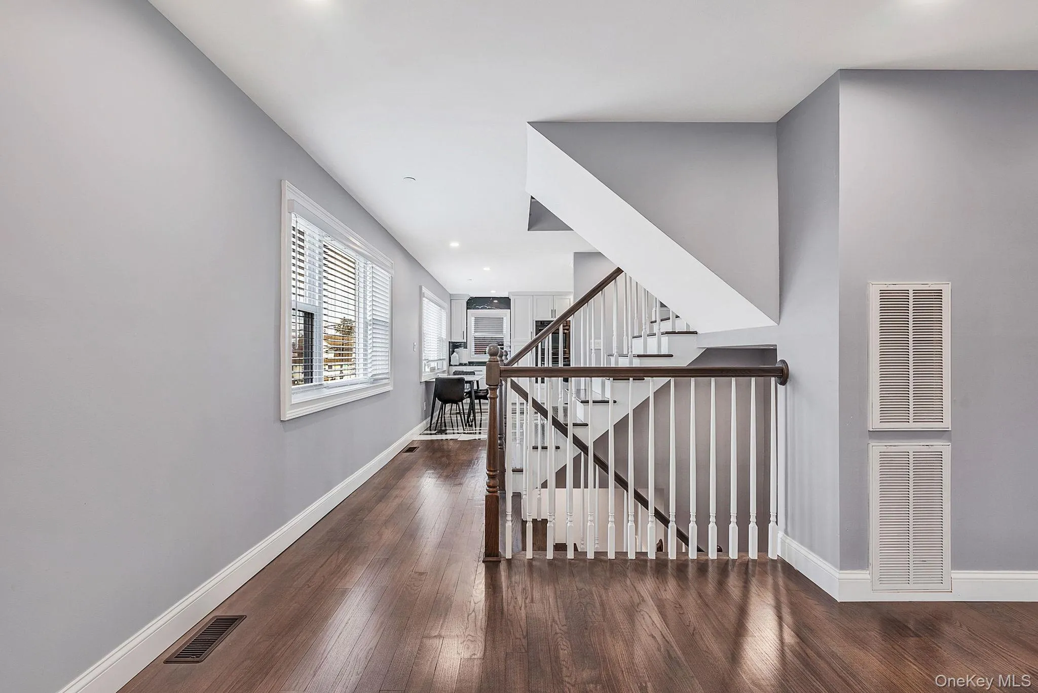 Hallway with recessed lighting, dark wood finished floors, and stairs Hallway with recessed lighting, dark wood finished floors, and stairs
