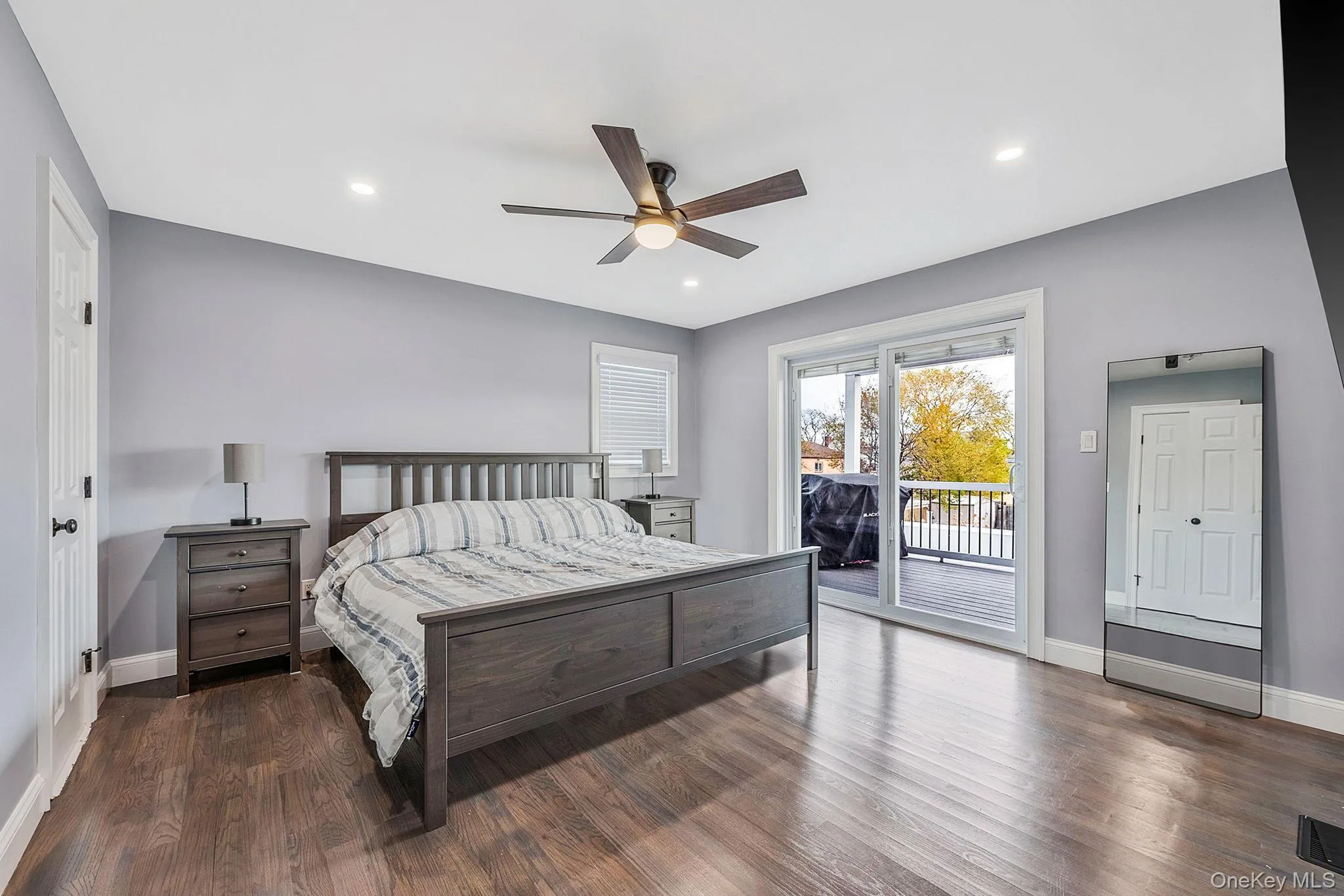 Bedroom featuring dark wood-style flooring, access to outside, ceiling fan, and recessed lighting Bedroom featuring dark wood-style flooring, access to outside, ceiling fan, and recessed lighting