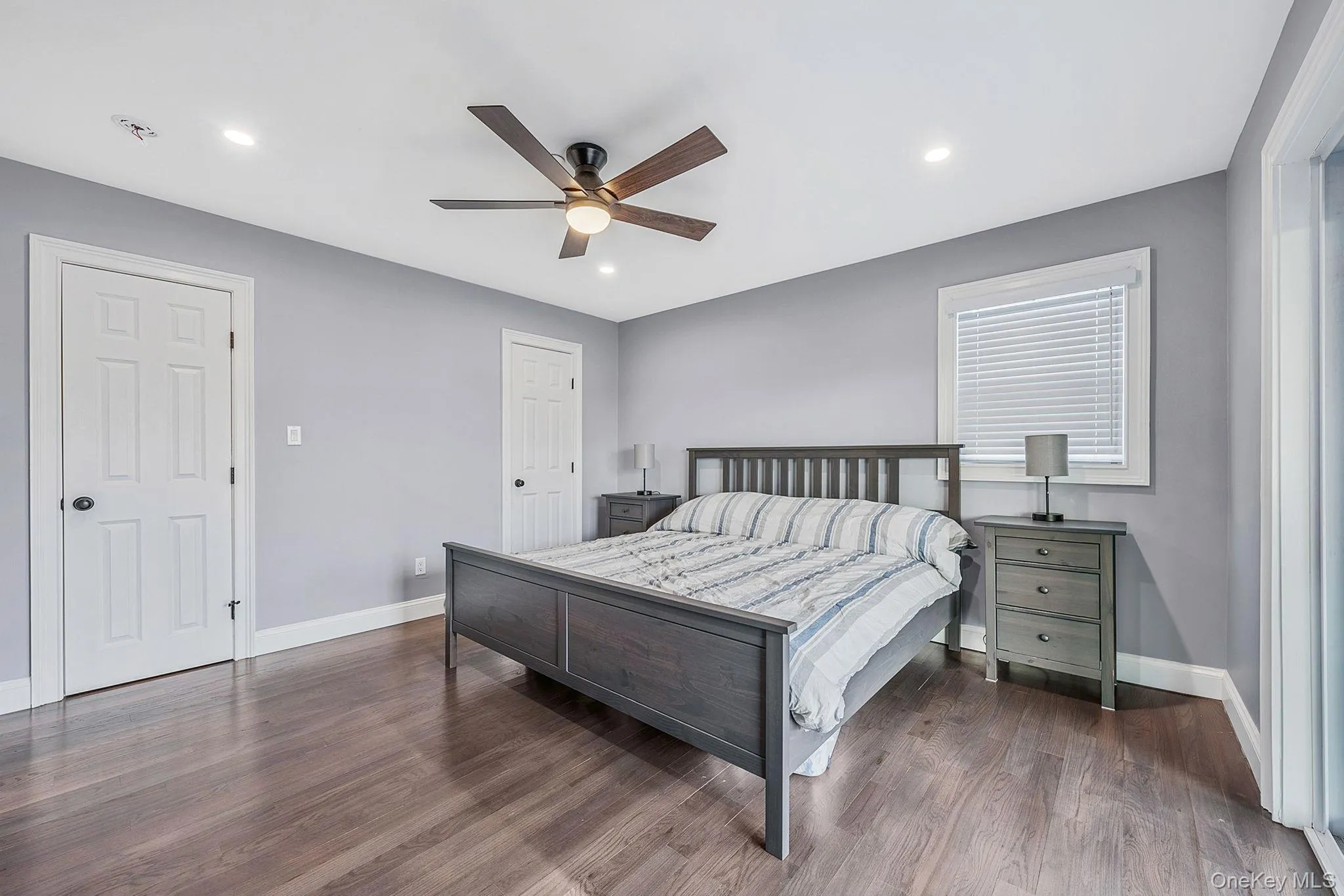 Bedroom with wood finished floors, ceiling fan, and recessed lighting Bedroom with wood finished floors, ceiling fan, and recessed lighting