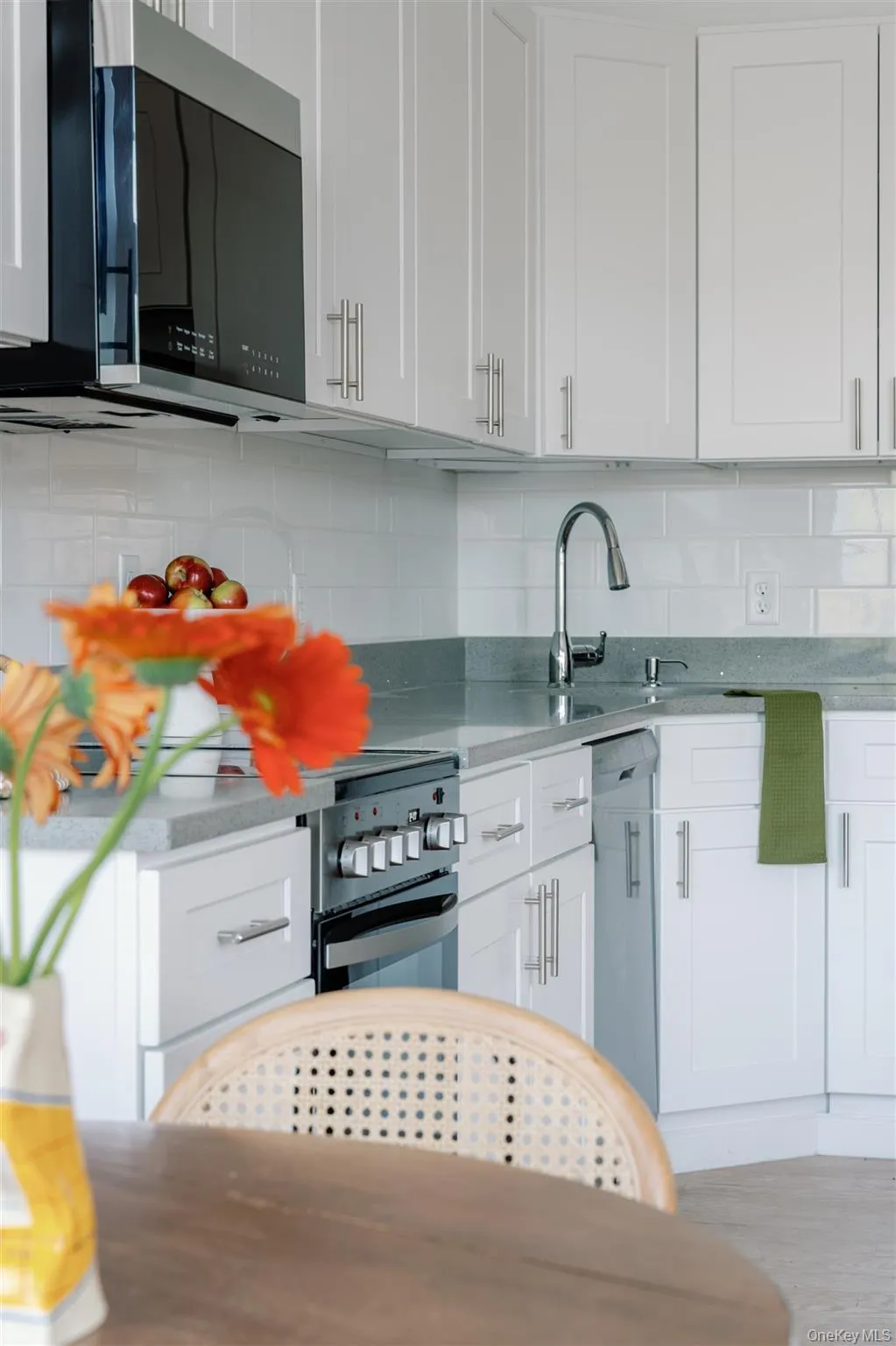 Kitchen featuring white cabinets and light stone counters Kitchen featuring white cabinets and light stone counters