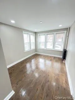 Unfurnished room with dark wood-style flooring and recessed lighting Unfurnished room with dark wood-style flooring and recessed lighting