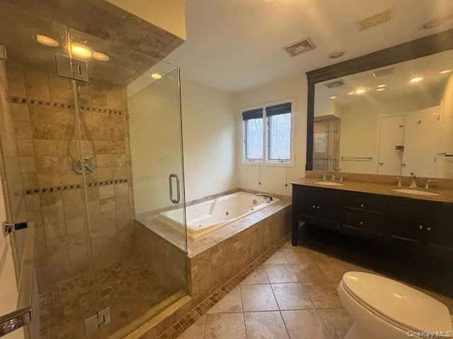 Full bath with a stall shower,double vanity, and a soaking tub Full bath with a stall shower,double vanity, and a soaking tub