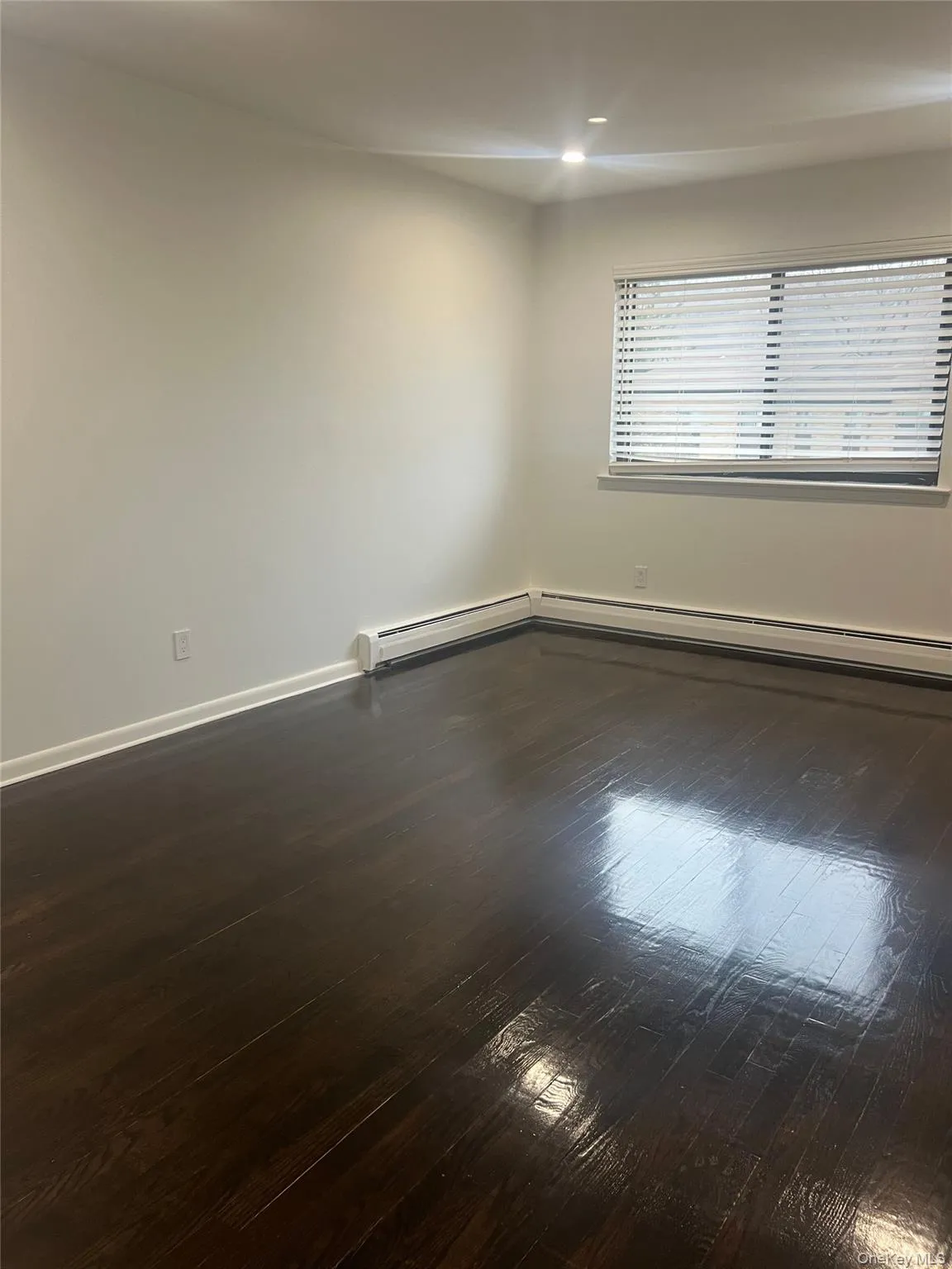 Spare room featuring dark wood-style floors and recessed lighting Spare room featuring dark wood-style floors and recessed lighting