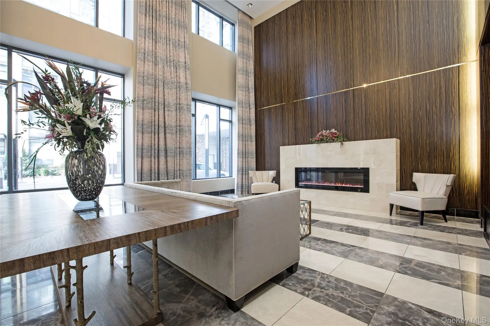 Lobby featuring a towering ceiling and wooden walls Lobby featuring a towering ceiling and wooden walls