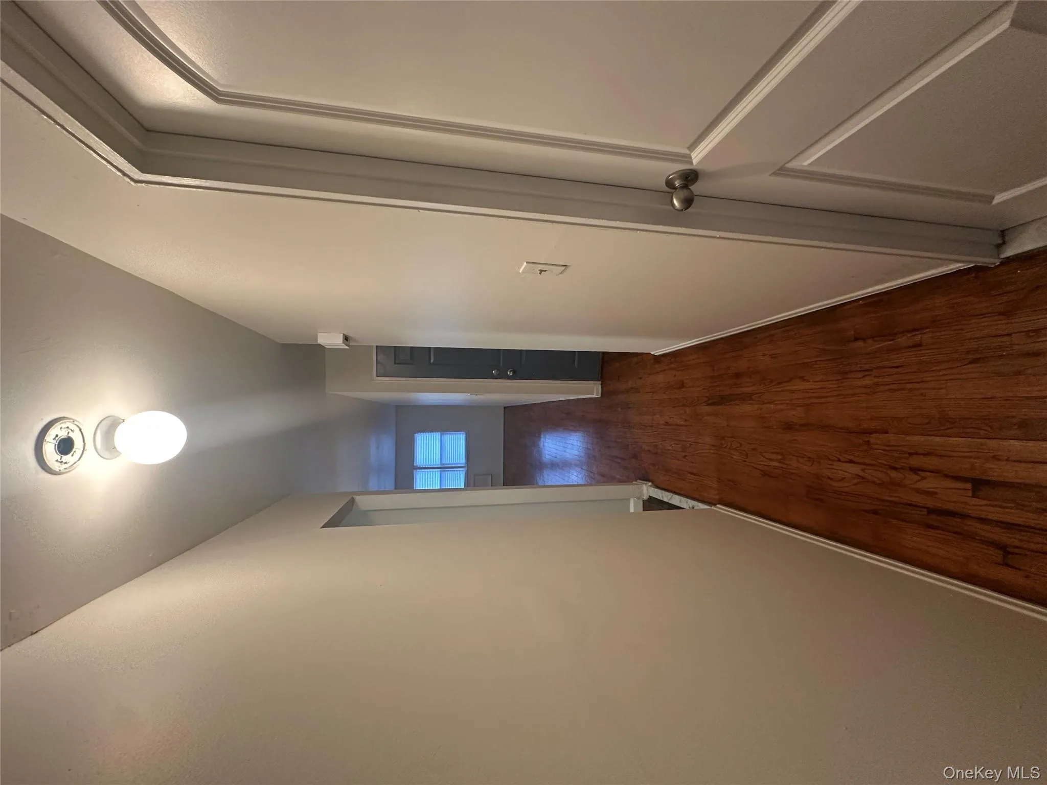 Corridor featuring baseboards and dark wood-style floors Corridor featuring baseboards and dark wood-style floors