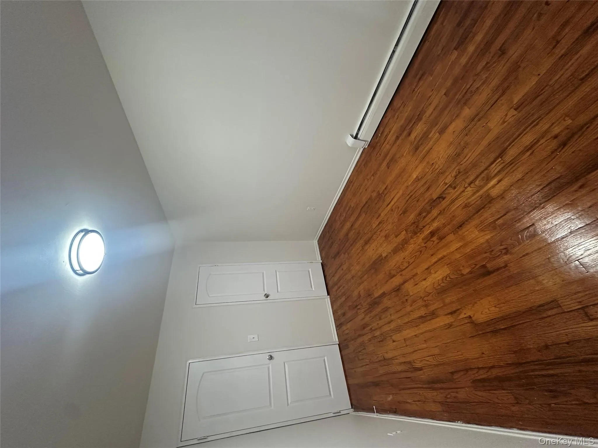 Unfurnished bedroom featuring a baseboard radiator and dark wood finished floors Unfurnished bedroom featuring a baseboard radiator and dark wood finished floors