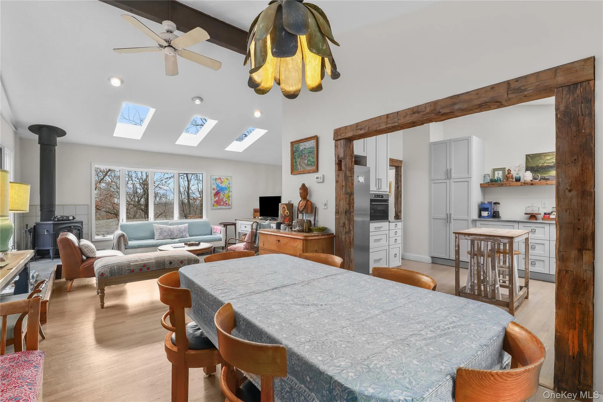 Dining area, view into Living Room with bay windows and wood stove Dining area, view into Living Room with bay windows and wood stove