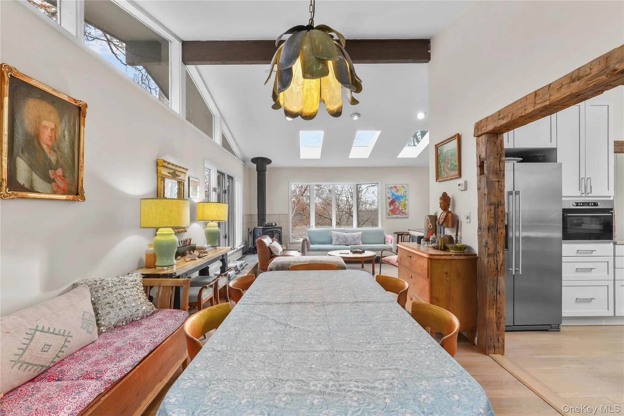 Dining area, view into Living Room with bay windows and wood stove Dining area, view into Living Room with bay windows and wood stove