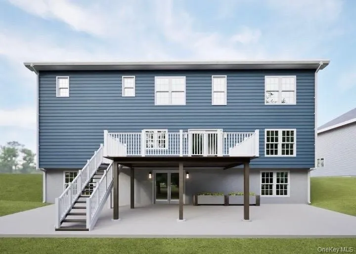 Back of house with a patio area, a lawn, a wooden deck, and stairs Back of house with a patio area, a lawn, a wooden deck, and stairs