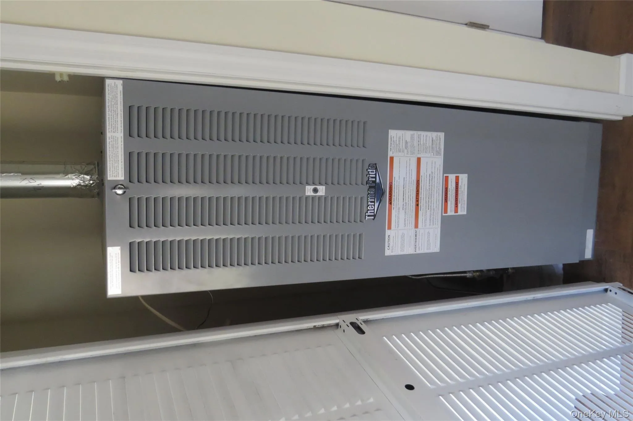 Interior details featuring a heating unit, wood finished floors, and heating unit Interior details featuring a heating unit, wood finished floors, and heating unit