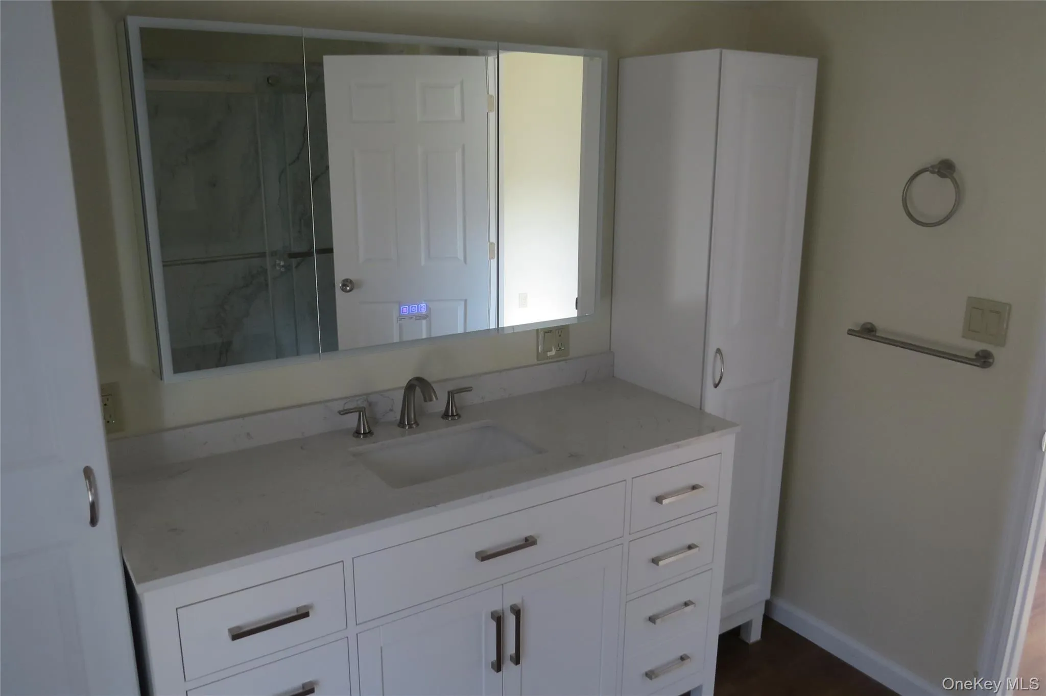 Bathroom featuring a shower stall, vanity, and baseboards Bathroom featuring a shower stall, vanity, and baseboards