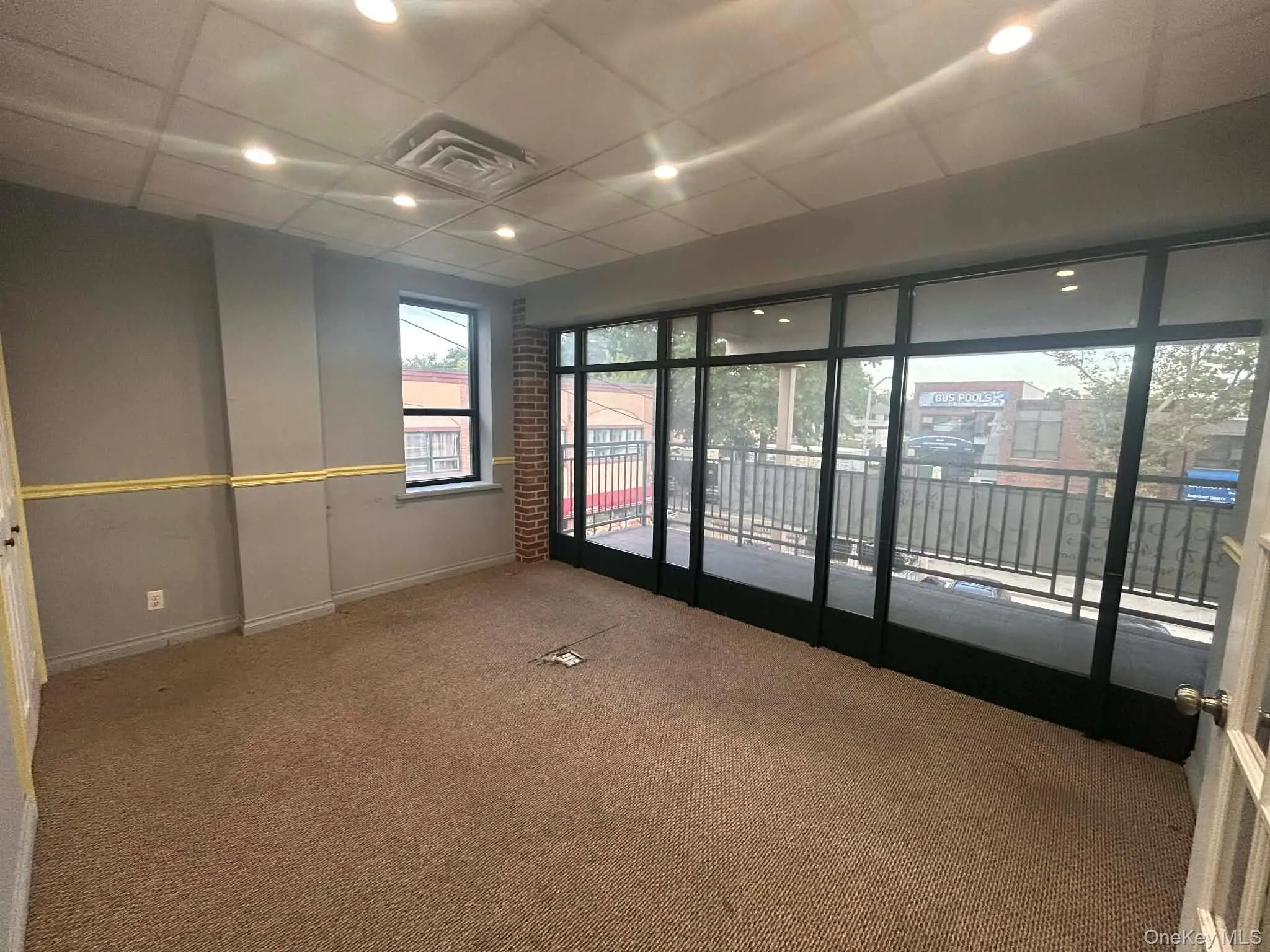 Unfurnished room featuring carpet, a drop ceiling, and recessed lighting Unfurnished room featuring carpet, a drop ceiling, and recessed lighting