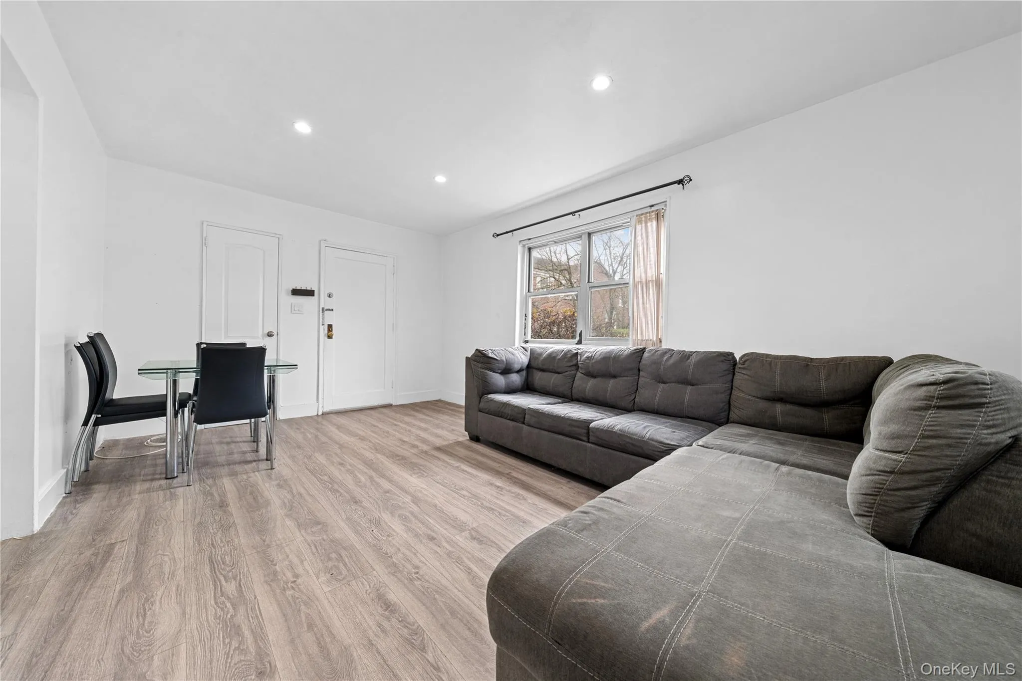 Living room featuring light wood-style floors and recessed lighting Living room featuring light wood-style floors and recessed lighting