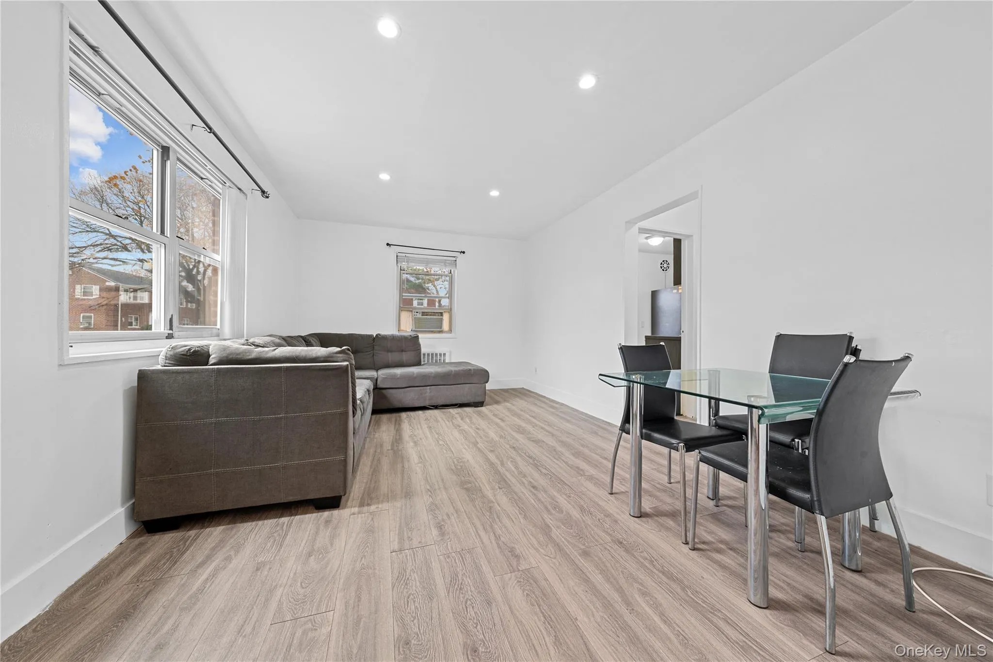 Living area with light wood-style flooring and recessed lighting Living area with light wood-style flooring and recessed lighting
