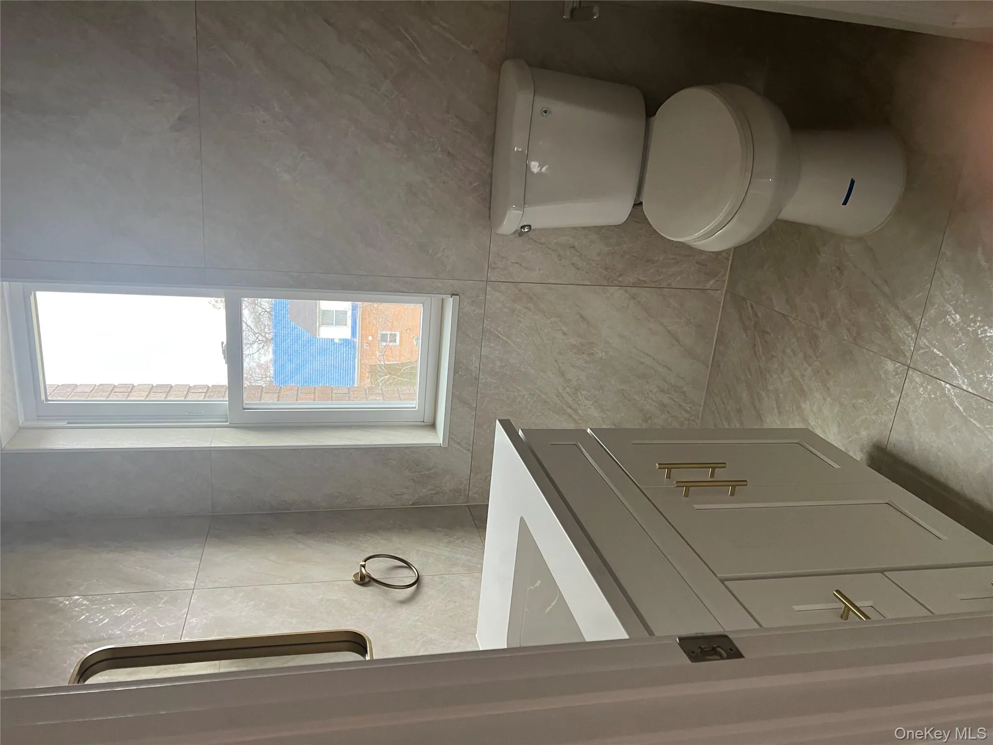 Half bath featuring vanity and tile walls Half bath featuring vanity and tile walls