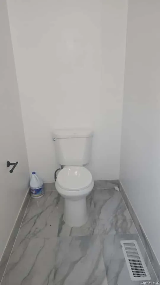 Bathroom with baseboards and marble finish floors Bathroom with baseboards and marble finish floors