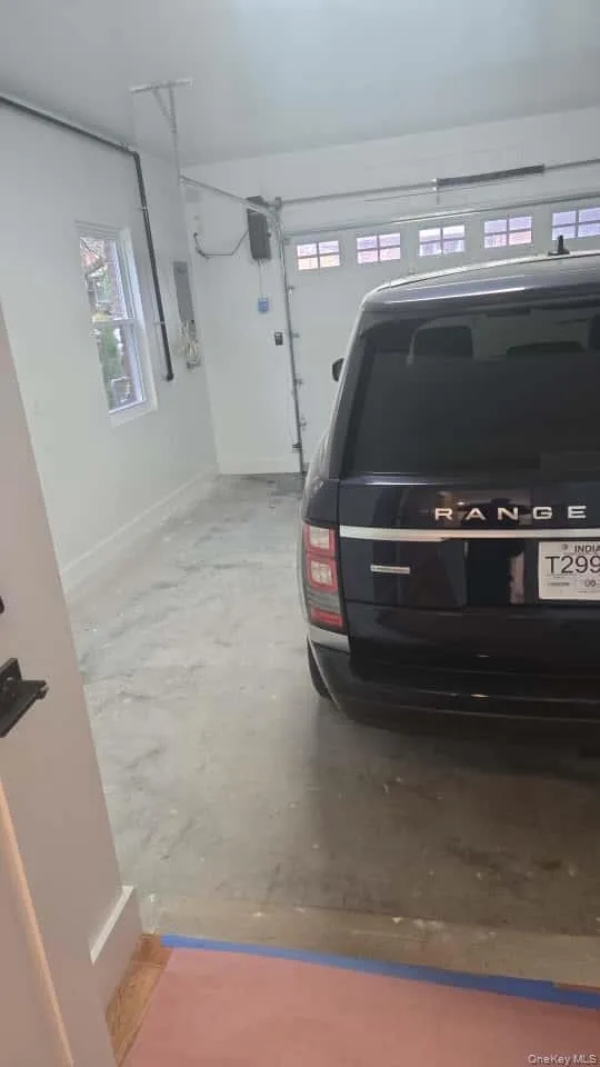Garage featuring baseboards Garage featuring baseboards