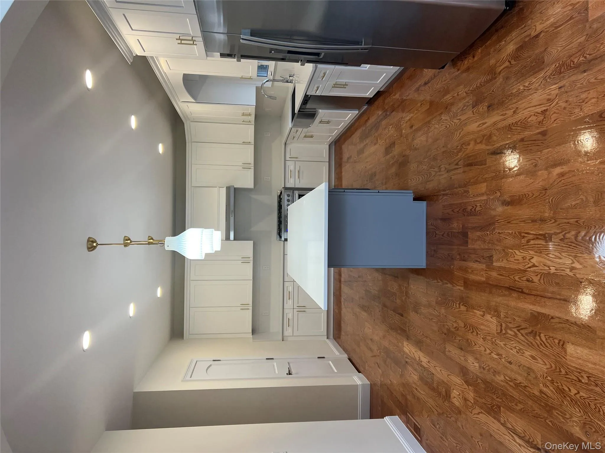 Kitchen with white cabinetry, refrigerator, pendant lighting, recessed lighting, and high end range Kitchen with white cabinetry, refrigerator, pendant lighting, recessed lighting, and high end range