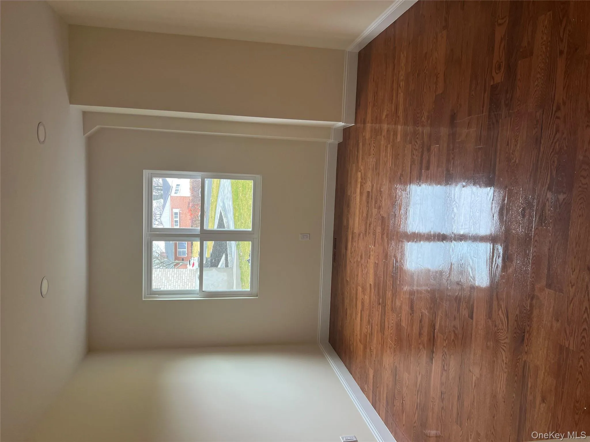 Empty room featuring baseboards and dark wood-type flooring Empty room featuring baseboards and dark wood-type flooring