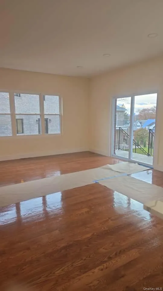 Unfurnished room featuring healthy amount of natural light and light wood finished floors Unfurnished room featuring healthy amount of natural light and light wood finished floors
