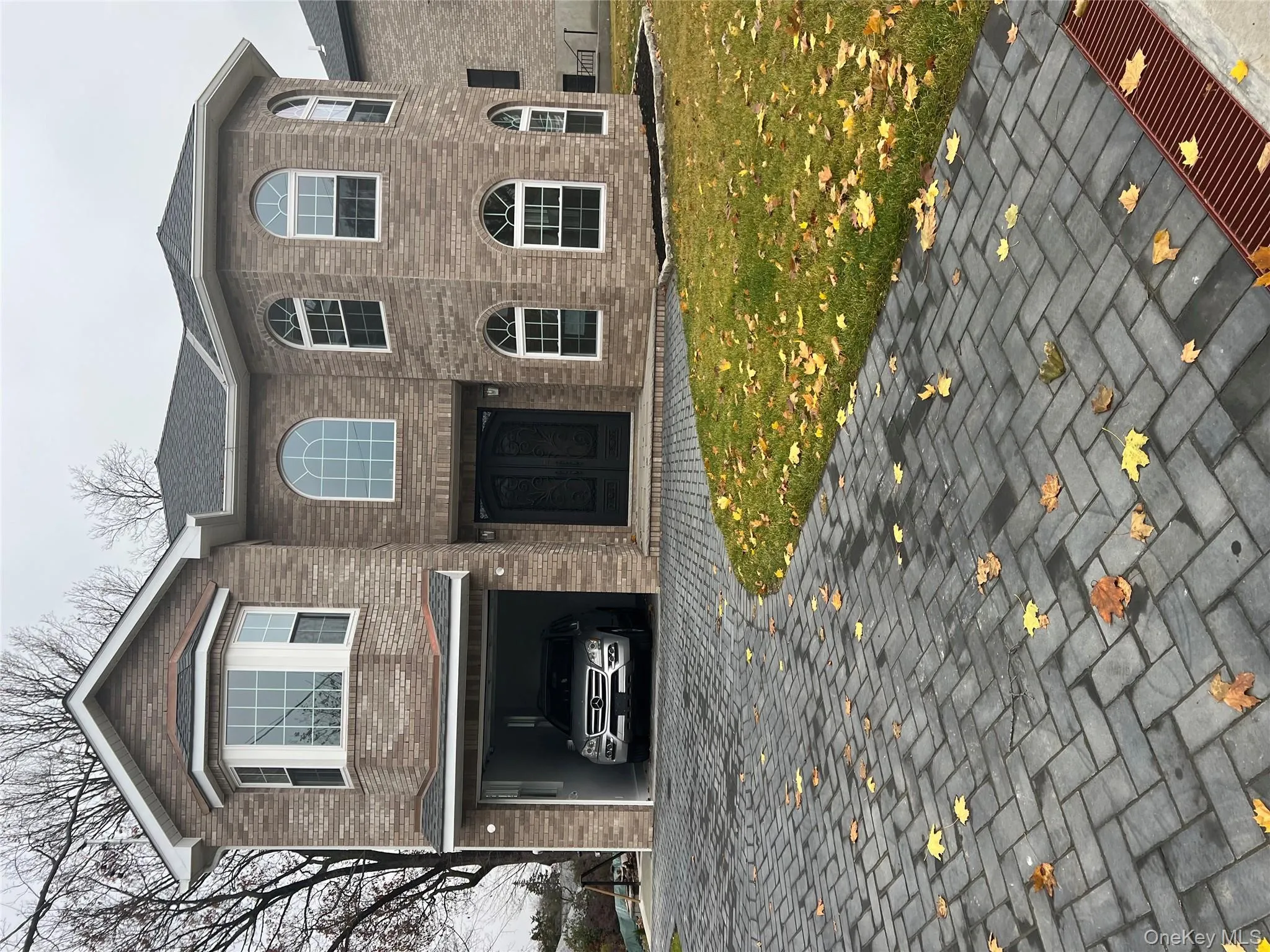 View of front of house with brick siding, a front lawn, and a shingled roof View of front of house with brick siding, a front lawn, and a shingled roof