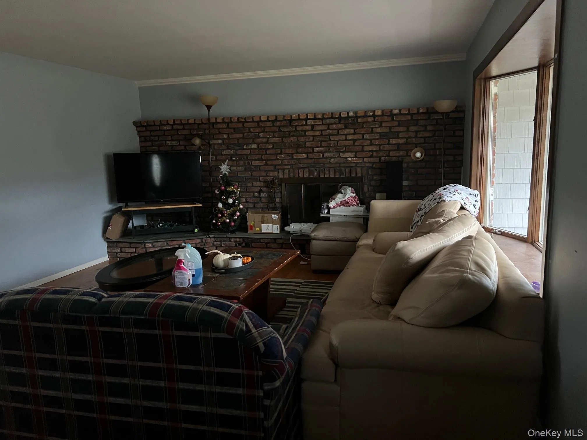 Living room featuring a fireplace and crown molding Living room featuring a fireplace and crown molding