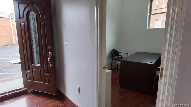 Foyer entrance featuring wood finish floors and baseboards Foyer entrance featuring wood finish floors and baseboards