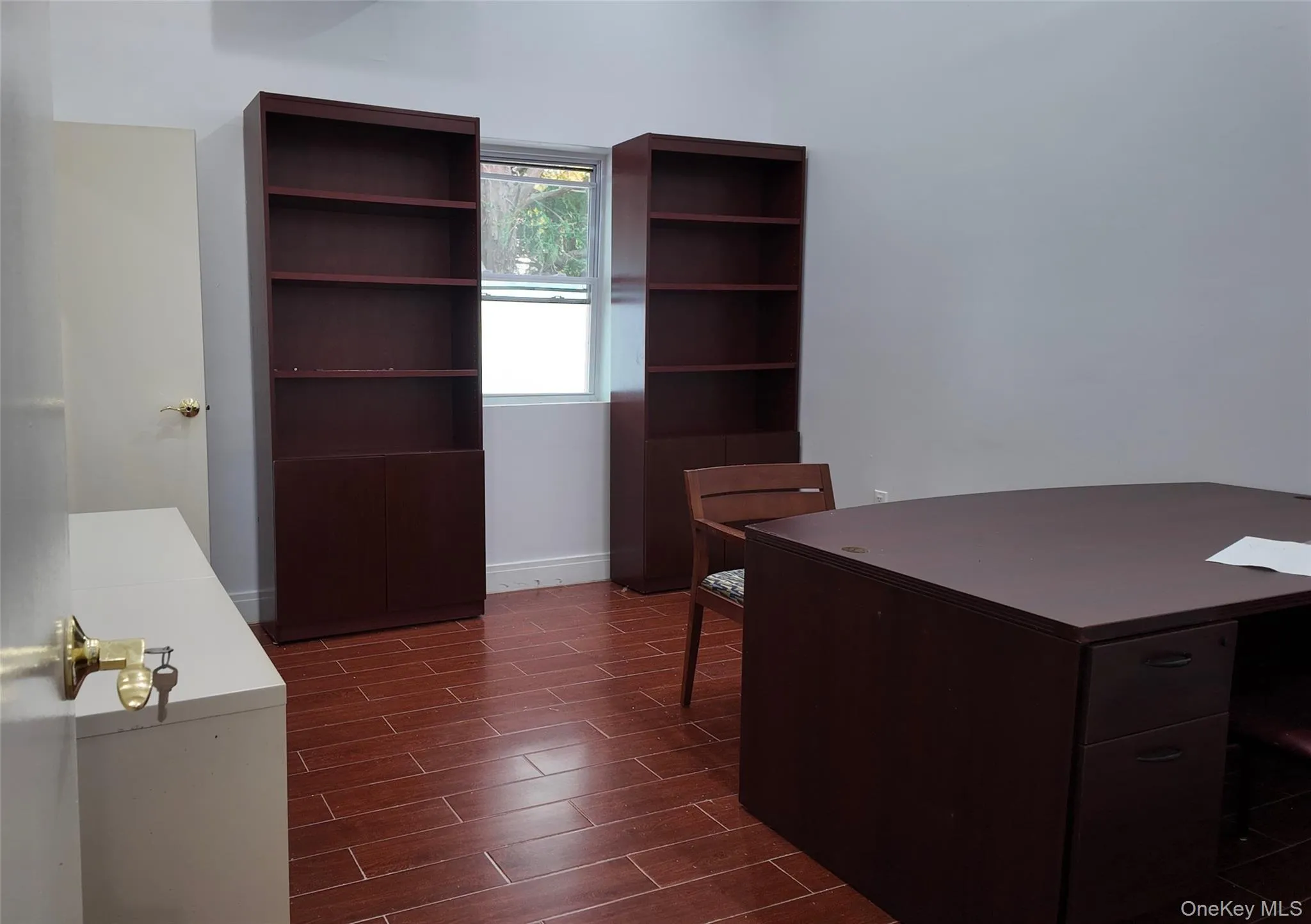 Unfurnished office featuring wood finish floors and baseboards Unfurnished office featuring wood finish floors and baseboards