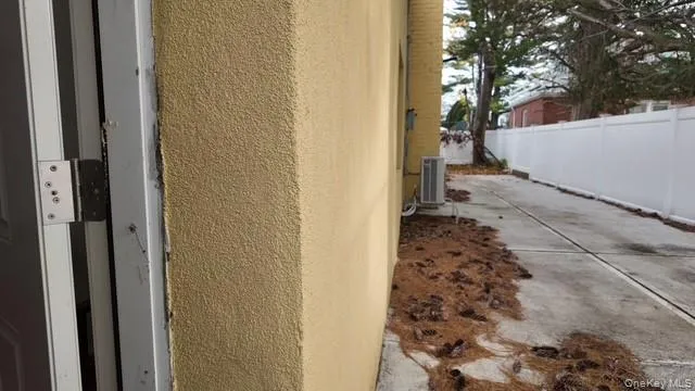Exterior view of stucco siding and a central air condition unit Exterior view of stucco siding and a central air condition unit