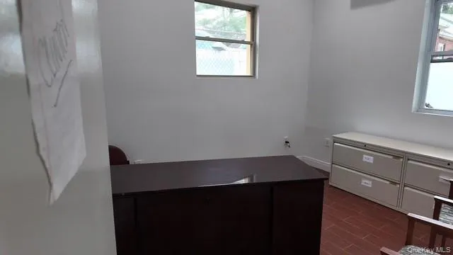 Unfurnished office featuring wood tiled floors Unfurnished office featuring wood tiled floors