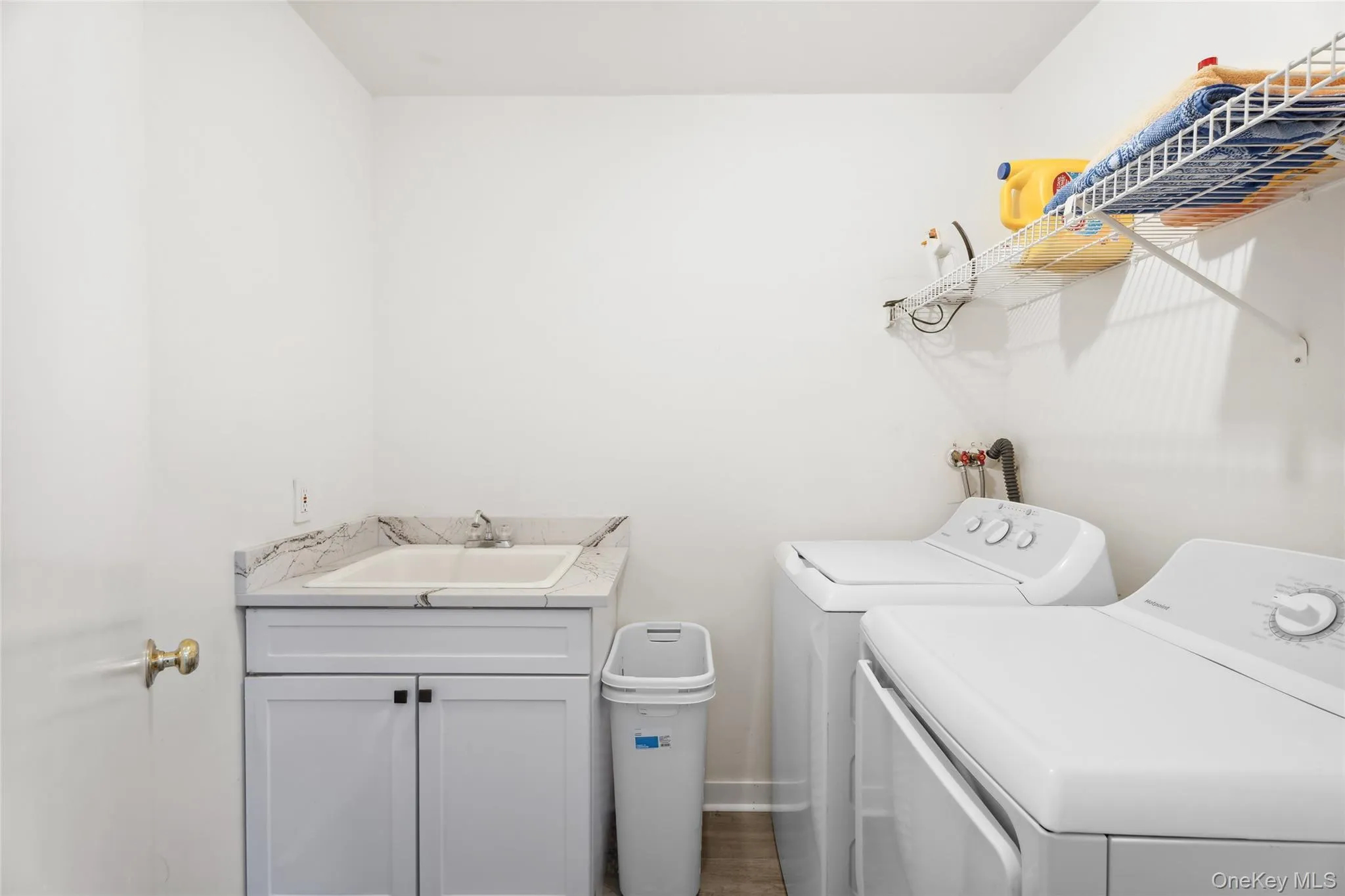 Laundry room featuring a sink and washer and dryer Laundry room featuring a sink and washer and dryer