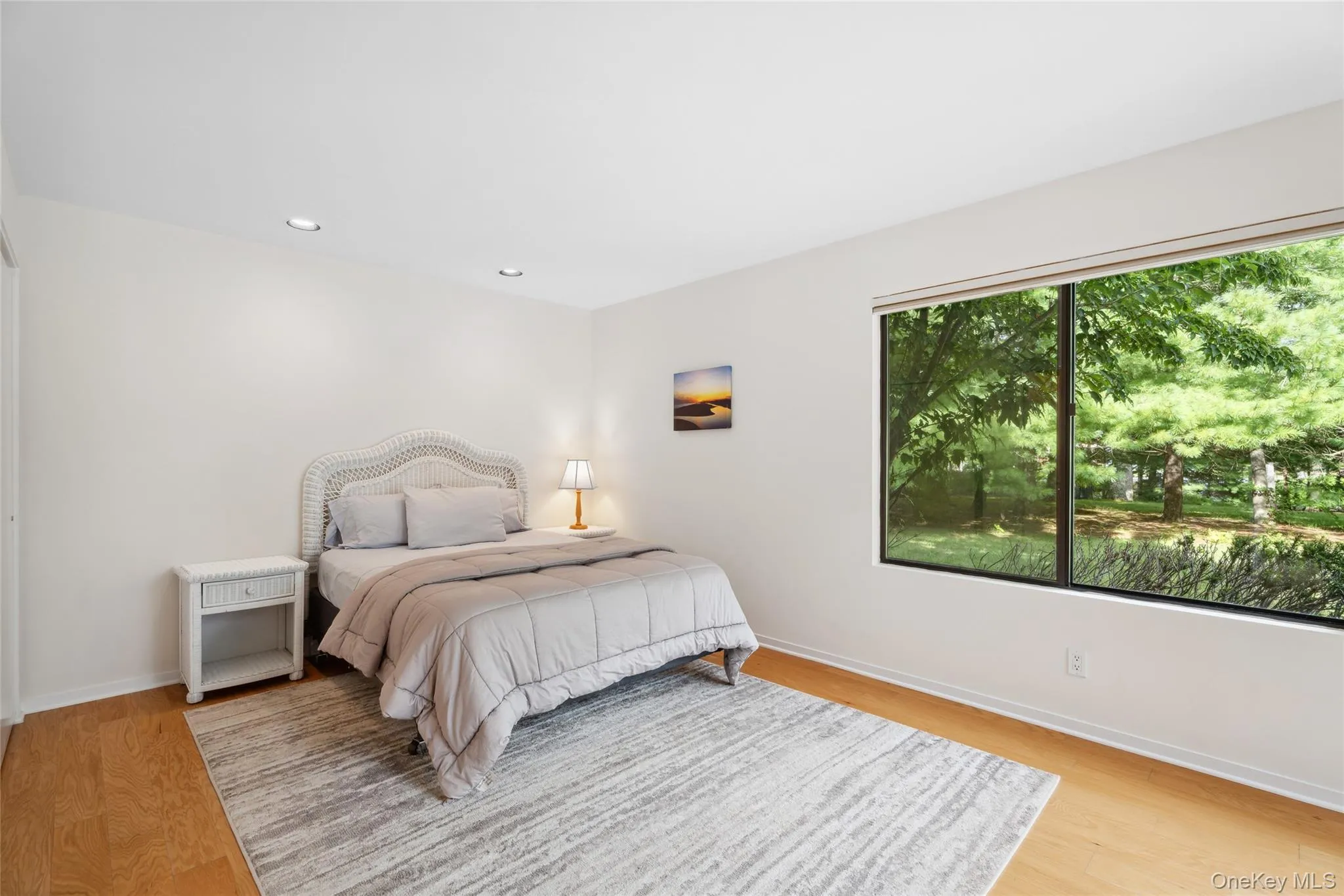 Bedroom featuring light wood finished floors and recessed lighting Bedroom featuring light wood finished floors and recessed lighting