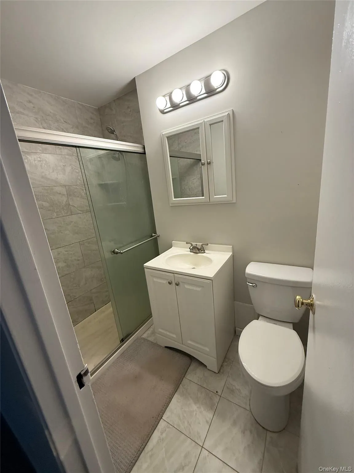 Full bathroom featuring a stall shower and vanity Full bathroom featuring a stall shower and vanity