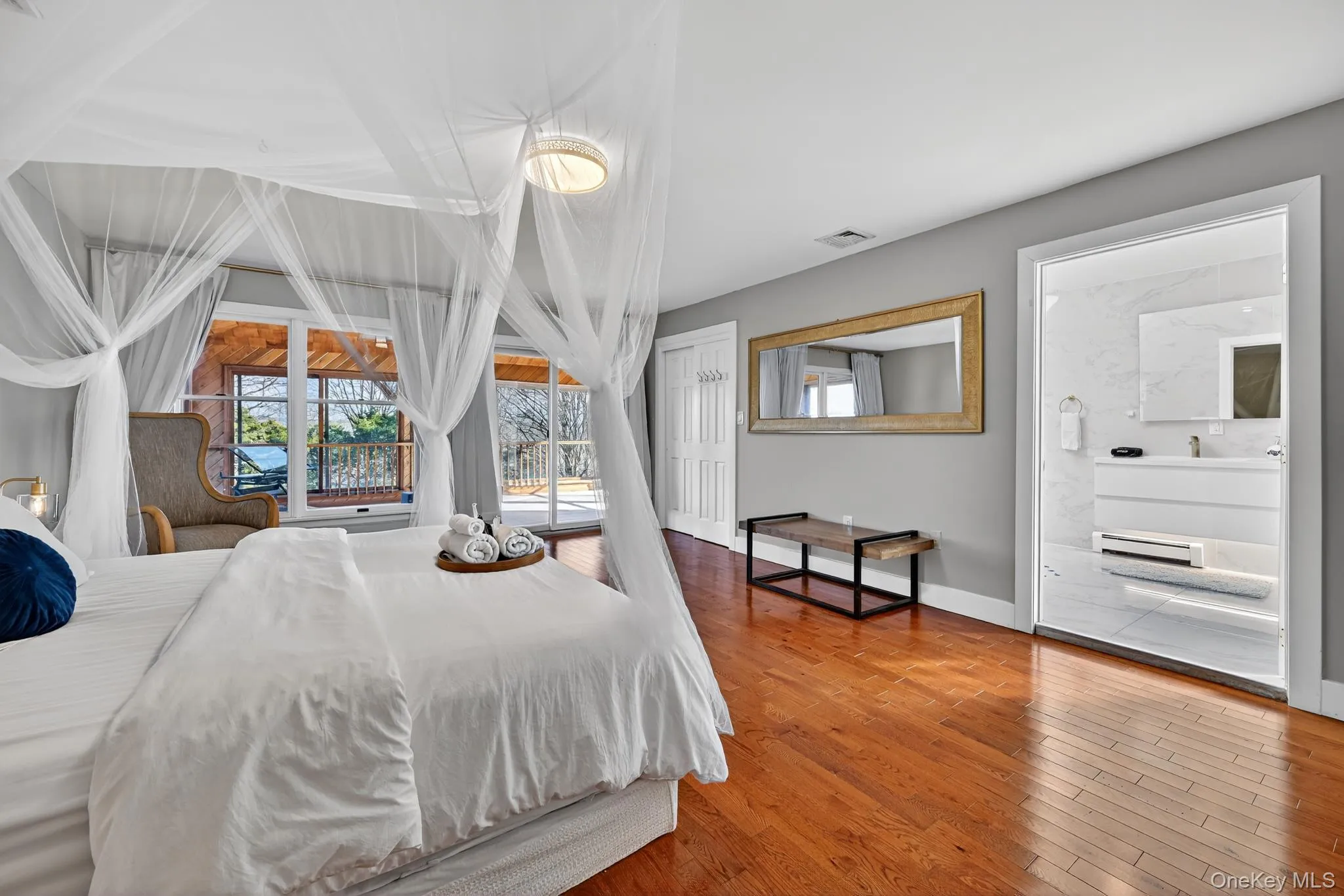 Primary Bedroom leading to glass doors for private Deck access Primary Bedroom leading to glass doors for private Deck access