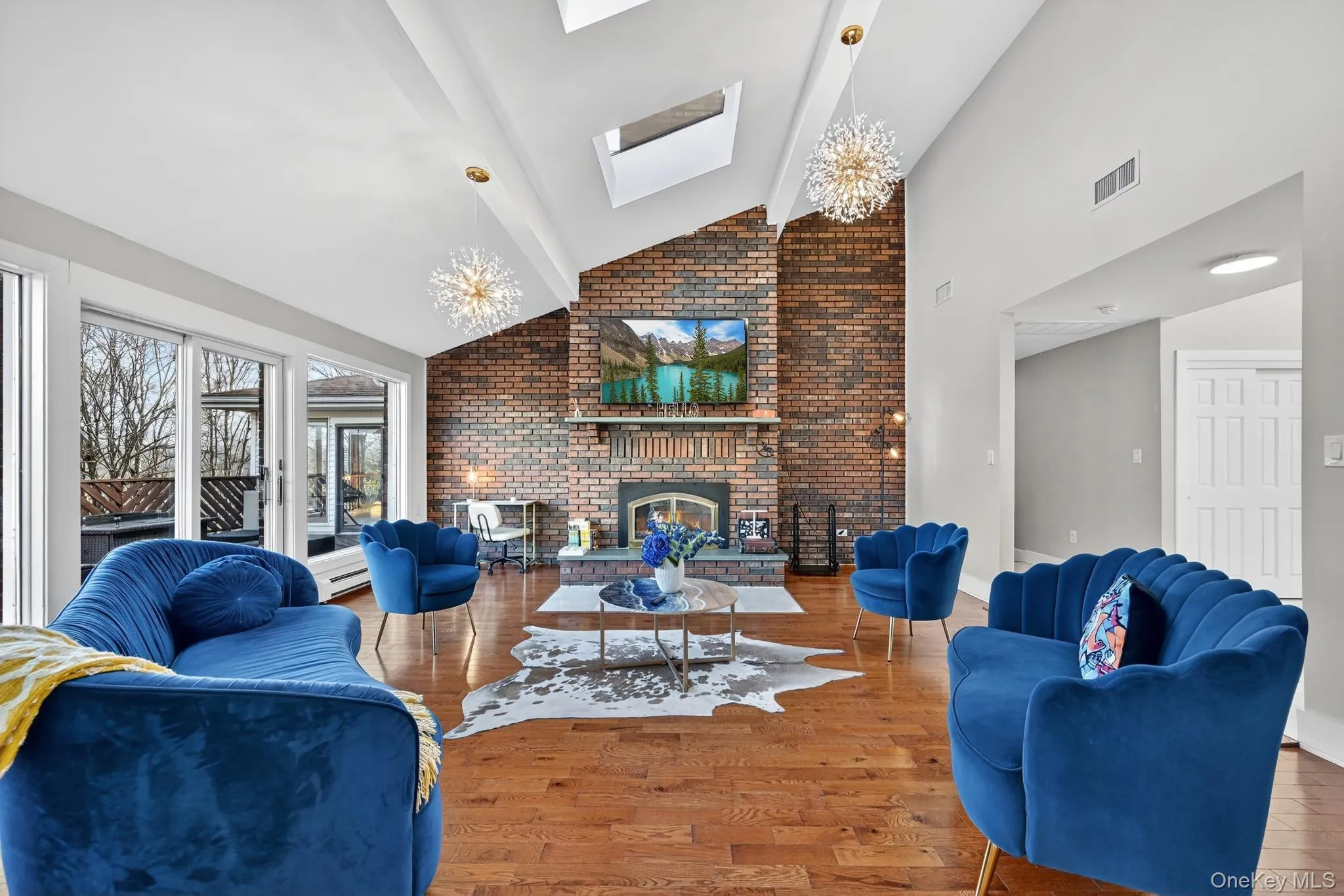 Bright Living Room with hardwood floors and large brick fireplace Bright Living Room with hardwood floors and large brick fireplace