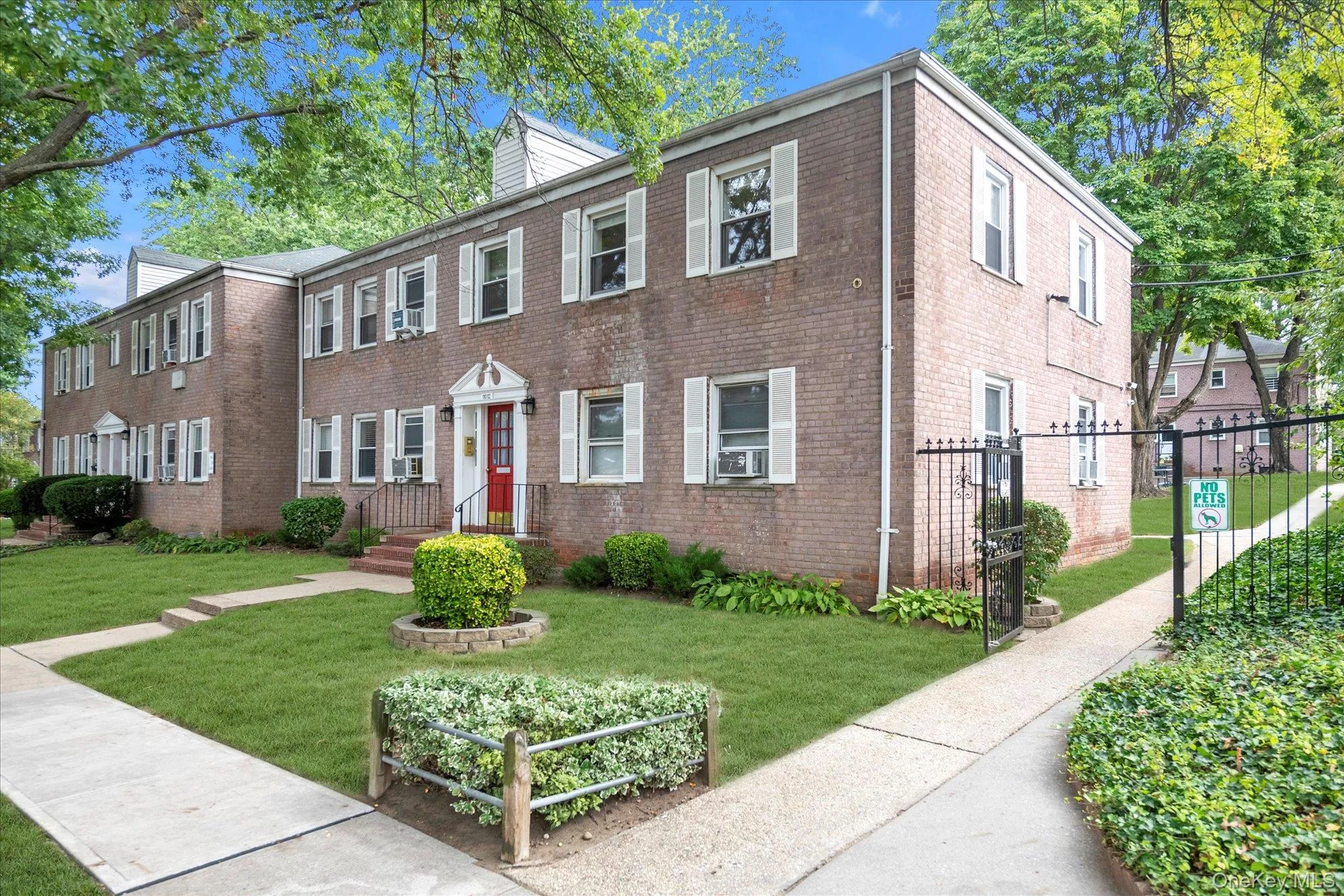 Colonial house with brick siding and a gate Colonial house with brick siding and a gate