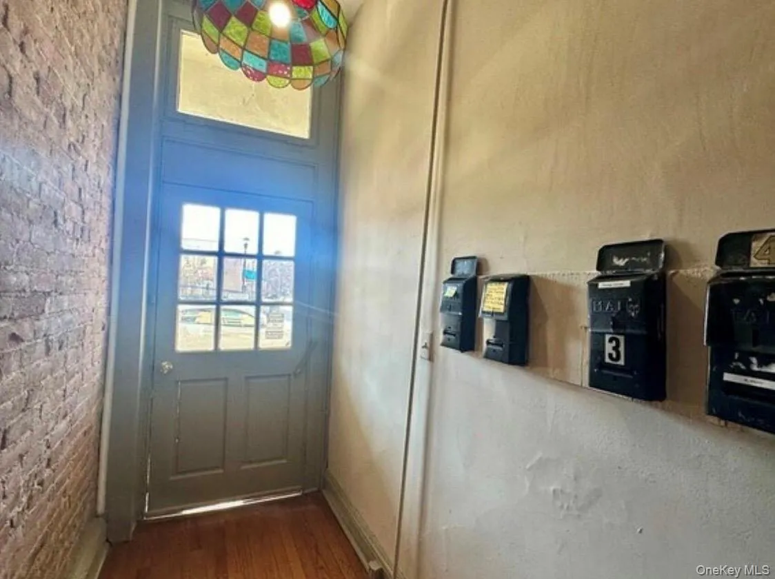 Doorway to outside with wood finished floors Doorway to outside with wood finished floors